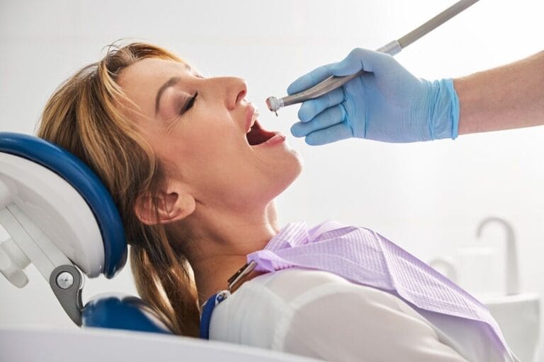 News 4 Woman patient widely opening her mouth before the drill